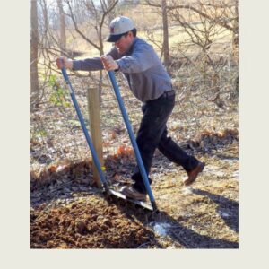 Gardener using the 7 Tine Unbreakable Broadfork to loosen compacted garden soil without tilling